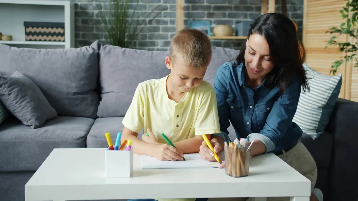 A mother helping her child study at home while planning JMI school admission 2027